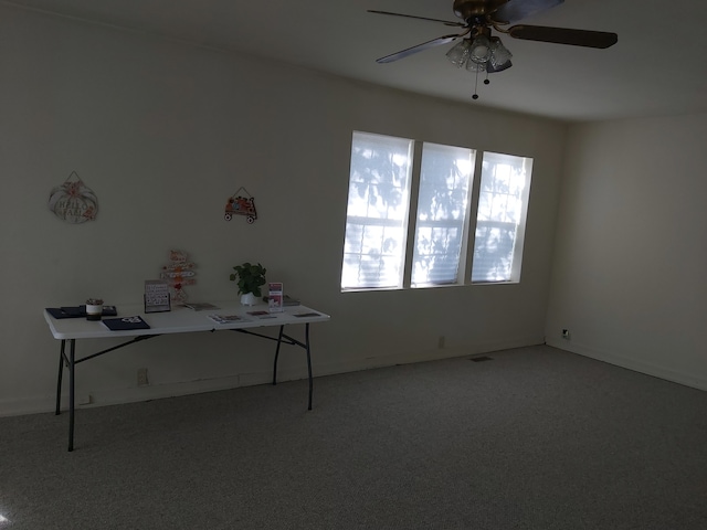 unfurnished office featuring ceiling fan and carpet flooring