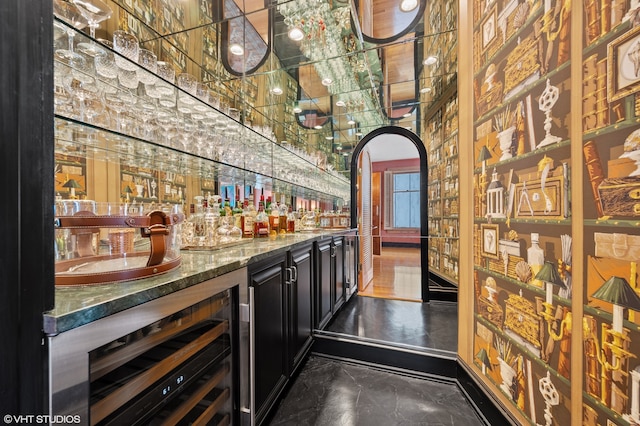 bar with dark stone counters and beverage cooler