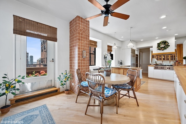 dining room featuring ceiling fan and light hardwood / wood-style flooring