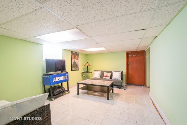 living room with a paneled ceiling