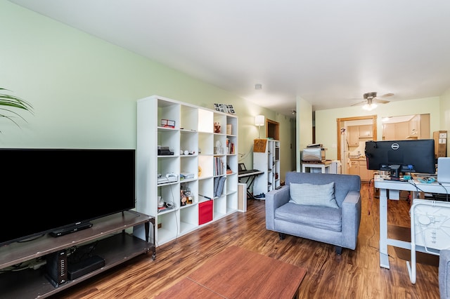 living room featuring ceiling fan and dark hardwood / wood-style flooring