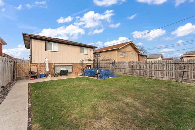 rear view of property with a lawn and a patio