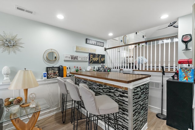 bar with light hardwood / wood-style flooring