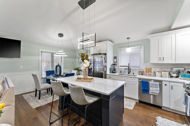 kitchen with a healthy amount of sunlight, decorative light fixtures, appliances with stainless steel finishes, and sink