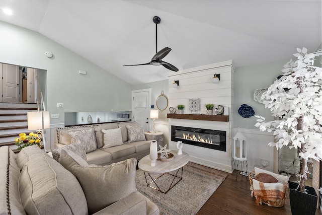 living room featuring ceiling fan, lofted ceiling, and dark wood-type flooring