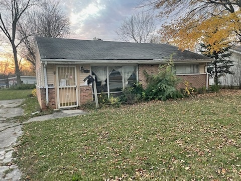 rear view of property with a lawn