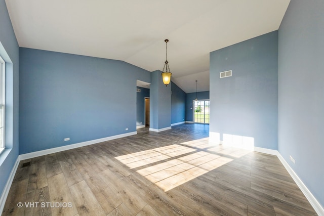 unfurnished room with lofted ceiling and wood-type flooring