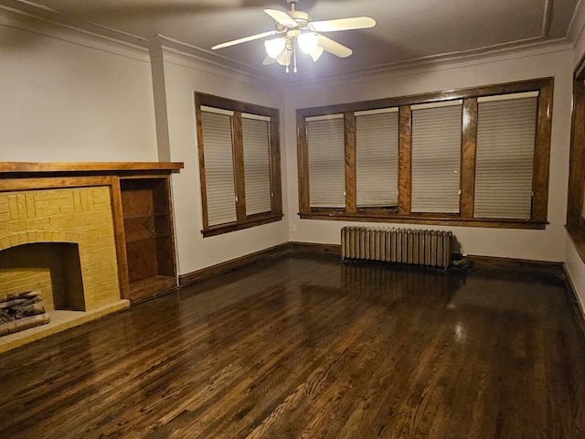 unfurnished living room with radiator heating unit, a fireplace, ornamental molding, and dark wood-type flooring