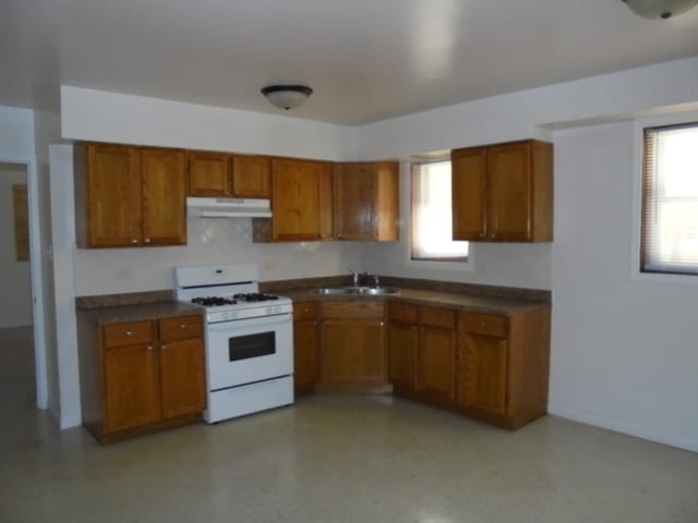 kitchen with white range with gas stovetop and sink