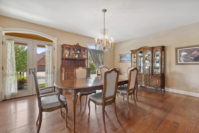 dining space with french doors, a chandelier, dark wood-type flooring, and a healthy amount of sunlight