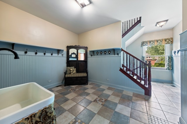 interior space featuring vaulted ceiling and tile flooring