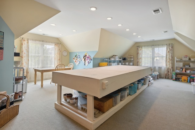 bedroom with light colored carpet and lofted ceiling