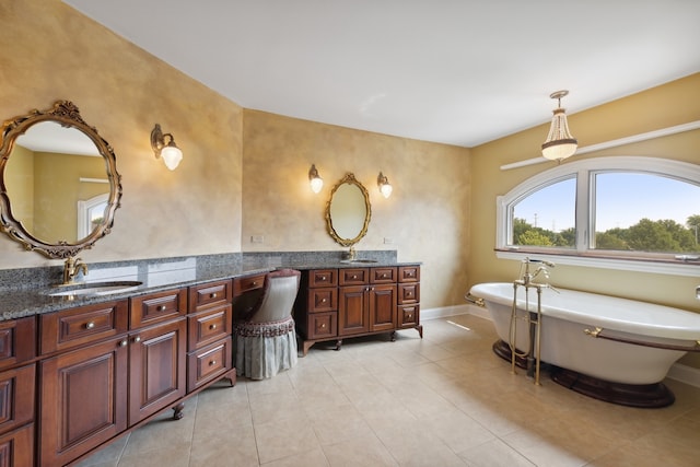 bathroom featuring a bath, vanity, and tile floors