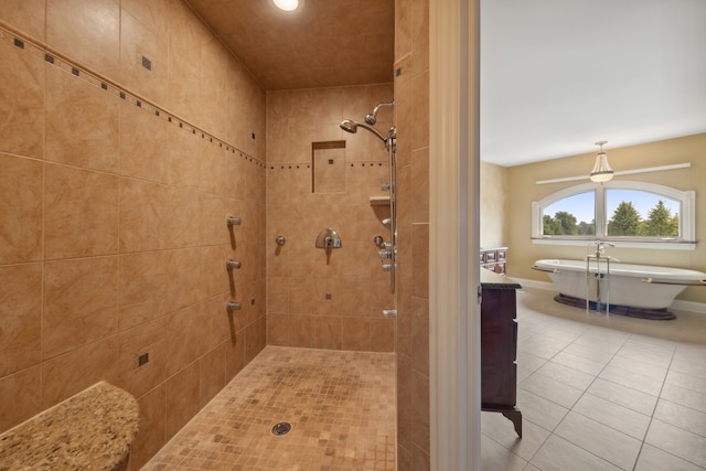 bathroom with tile flooring, a tile shower, and vanity