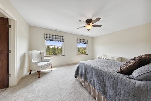 bedroom with light colored carpet and ceiling fan