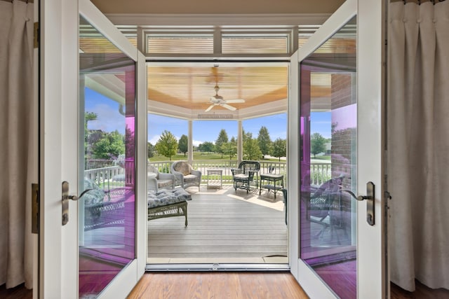 doorway featuring ceiling fan and hardwood / wood-style flooring