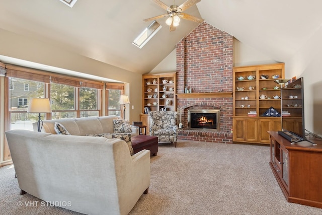 living room featuring ceiling fan, high vaulted ceiling, a brick fireplace, and light colored carpet