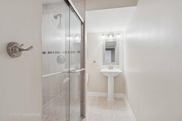 bathroom with a shower with door and toilet