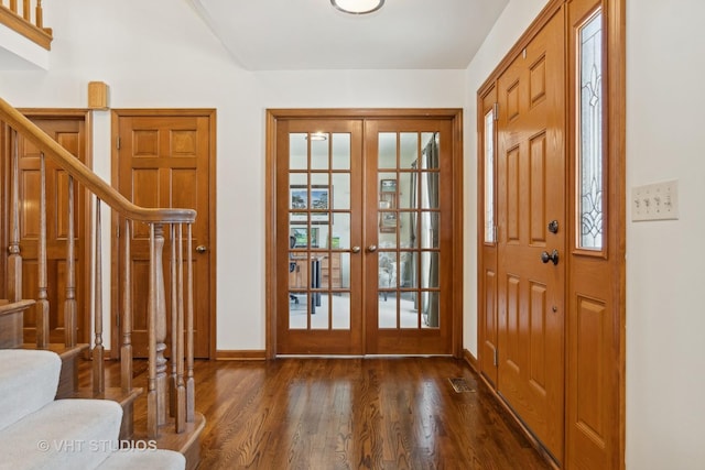 foyer with french doors and dark hardwood / wood-style flooring