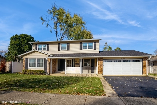 view of front property with a porch, a garage, and a front lawn