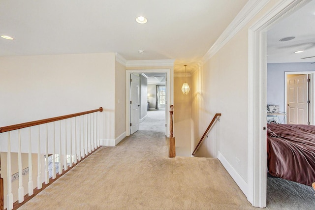 hallway featuring light colored carpet and crown molding