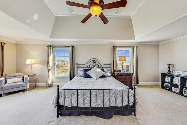 carpeted bedroom featuring a tray ceiling, ceiling fan, and ornamental molding