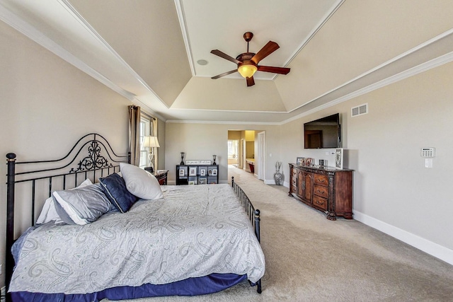 bedroom featuring carpet flooring, ceiling fan, crown molding, vaulted ceiling, and a tray ceiling