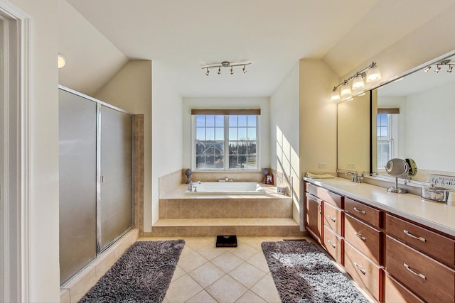 bathroom with tile patterned floors, vanity, plus walk in shower, and vaulted ceiling