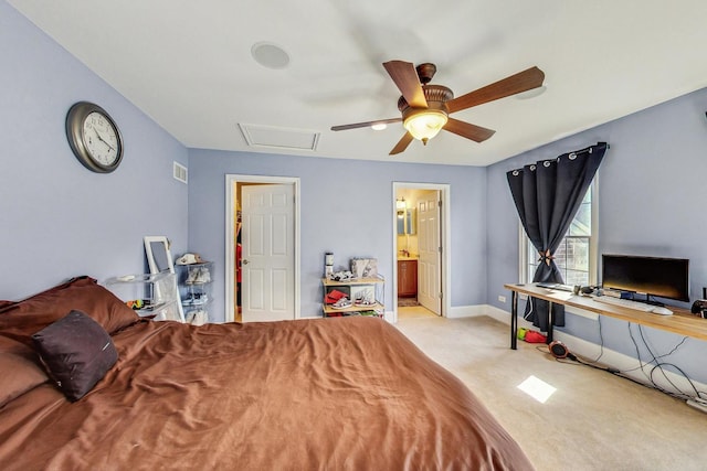 bedroom with connected bathroom, light colored carpet, and ceiling fan