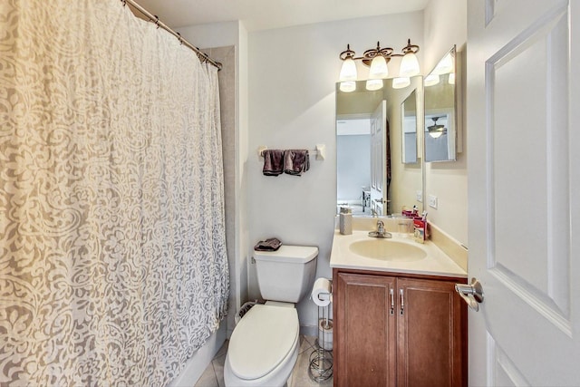 bathroom featuring tile patterned flooring, vanity, and toilet