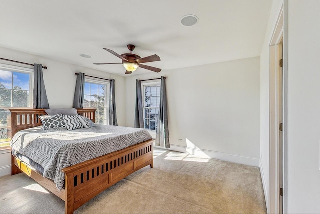 bedroom featuring light carpet and ceiling fan