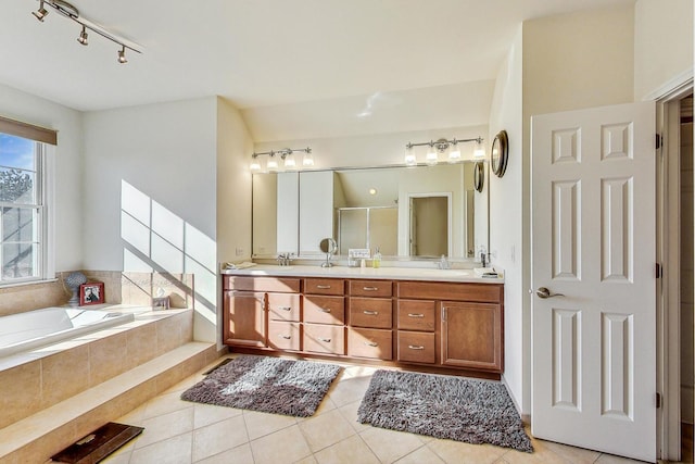 bathroom featuring shower with separate bathtub, vanity, and tile patterned floors