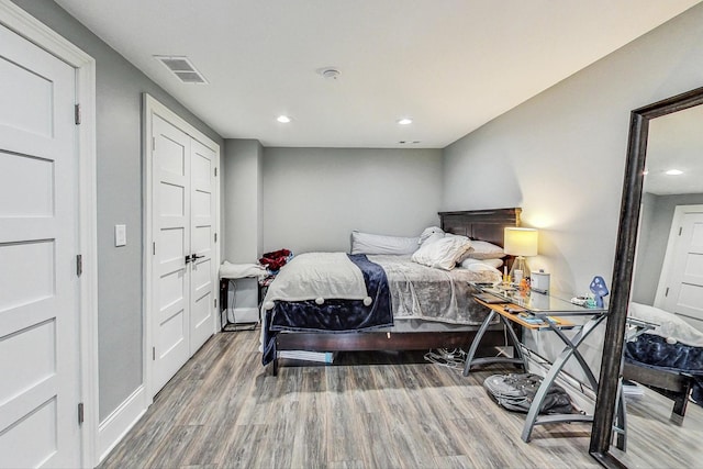 bedroom with wood-type flooring