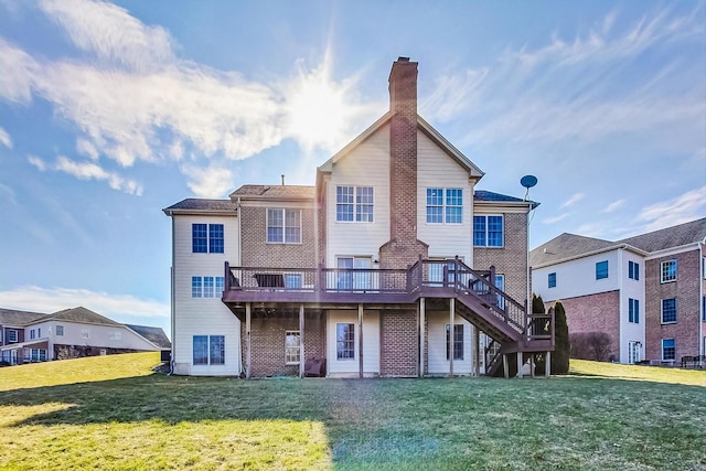 back of property with a deck and a lawn