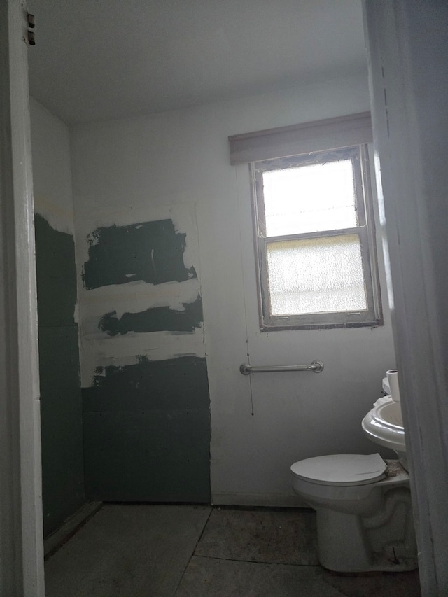 bathroom with toilet and tile flooring