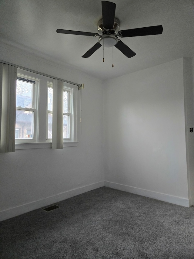 carpeted spare room with ceiling fan