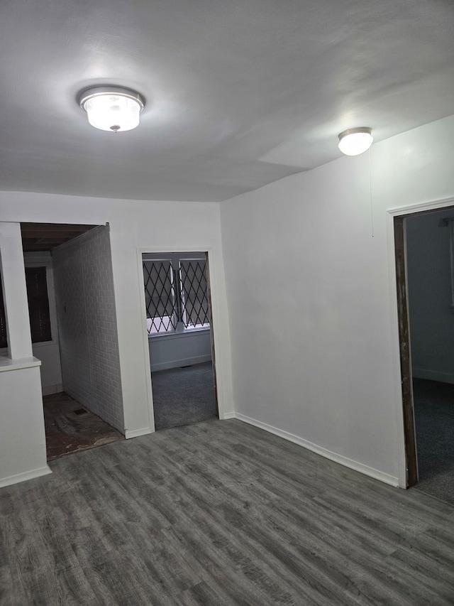 spare room with dark hardwood / wood-style flooring