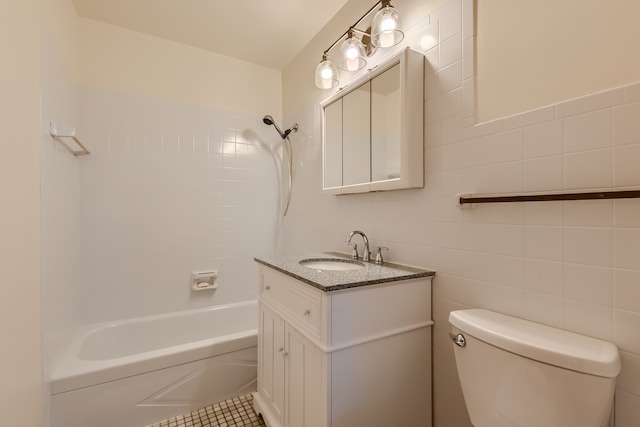 full bathroom with tiled shower / bath combo, toilet, tile flooring, vanity, and tile walls