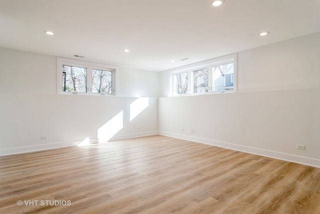 empty room with light hardwood / wood-style flooring