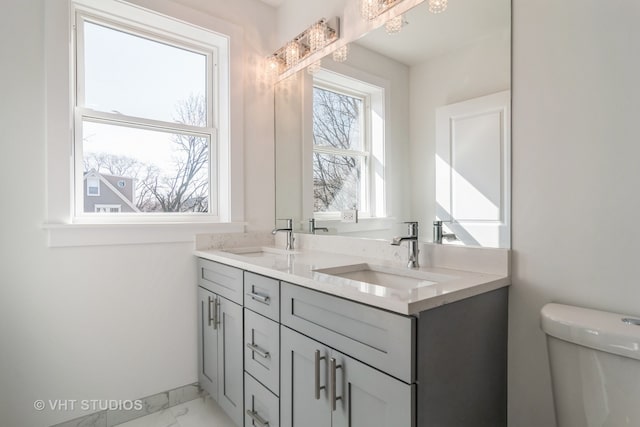 bathroom featuring dual bowl vanity, toilet, and tile floors