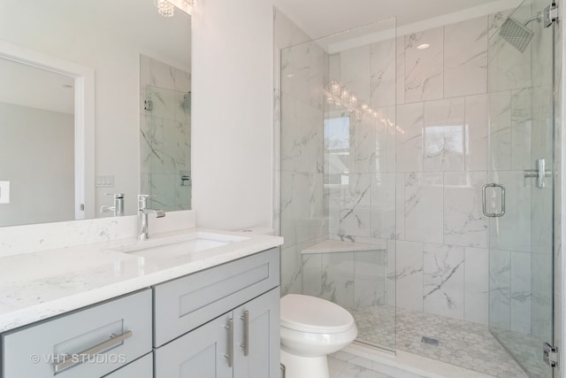 bathroom with tile flooring, walk in shower, vanity, and toilet