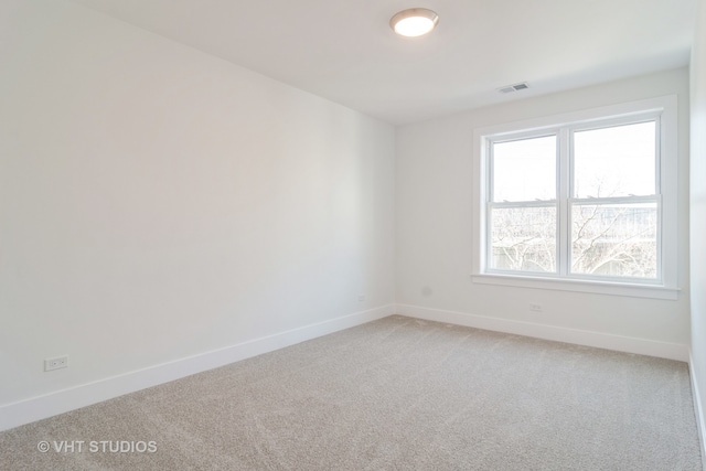 unfurnished room featuring carpet flooring and a healthy amount of sunlight