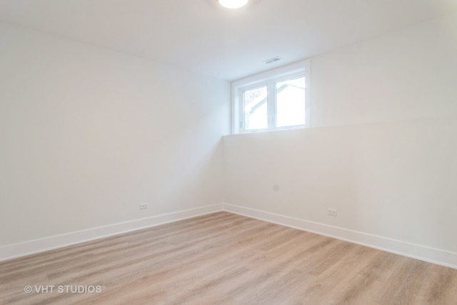 unfurnished room with light wood-type flooring