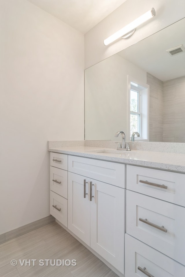 bathroom featuring tile flooring and large vanity