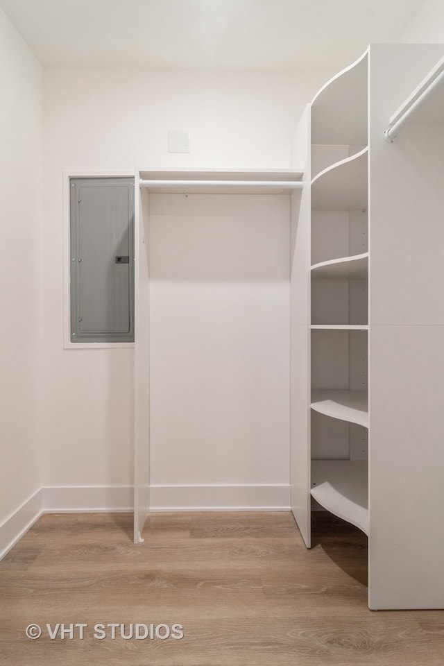 walk in closet with light hardwood / wood-style floors