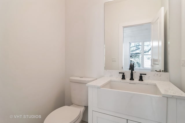 bathroom with toilet and large vanity