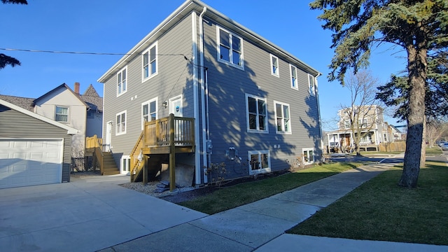 exterior space with a garage and a lawn