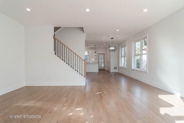 foyer entrance featuring a chandelier and light hardwood / wood-style flooring