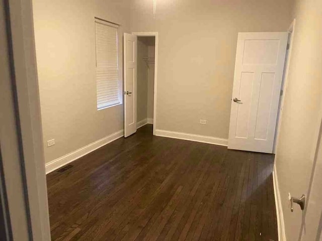 spare room featuring dark hardwood / wood-style flooring