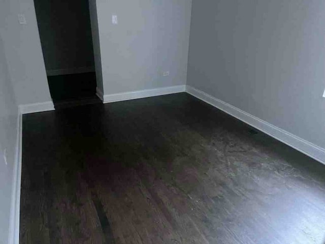 empty room with dark hardwood / wood-style floors